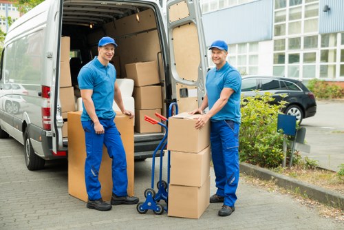 Worker using protective equipment while moving items for a removal