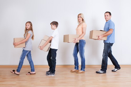 Moving team estimating cubic-yard volume for a family house relocation
